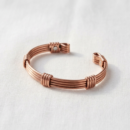 Vera's Sere Copper Bracelet on white linen background