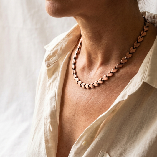 Vera's Briar Copper Necklace on white linen background
