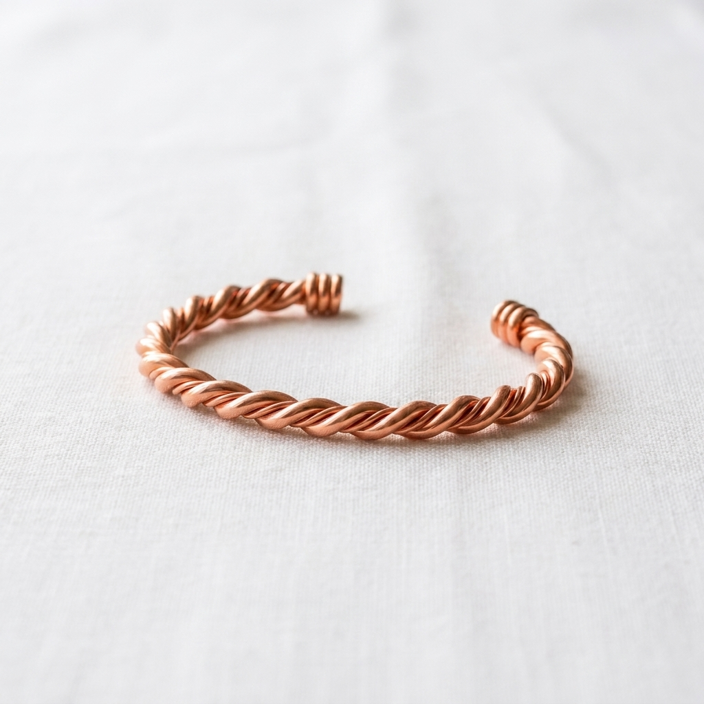 Vera's Tensor Copper Bracelet on white linen background